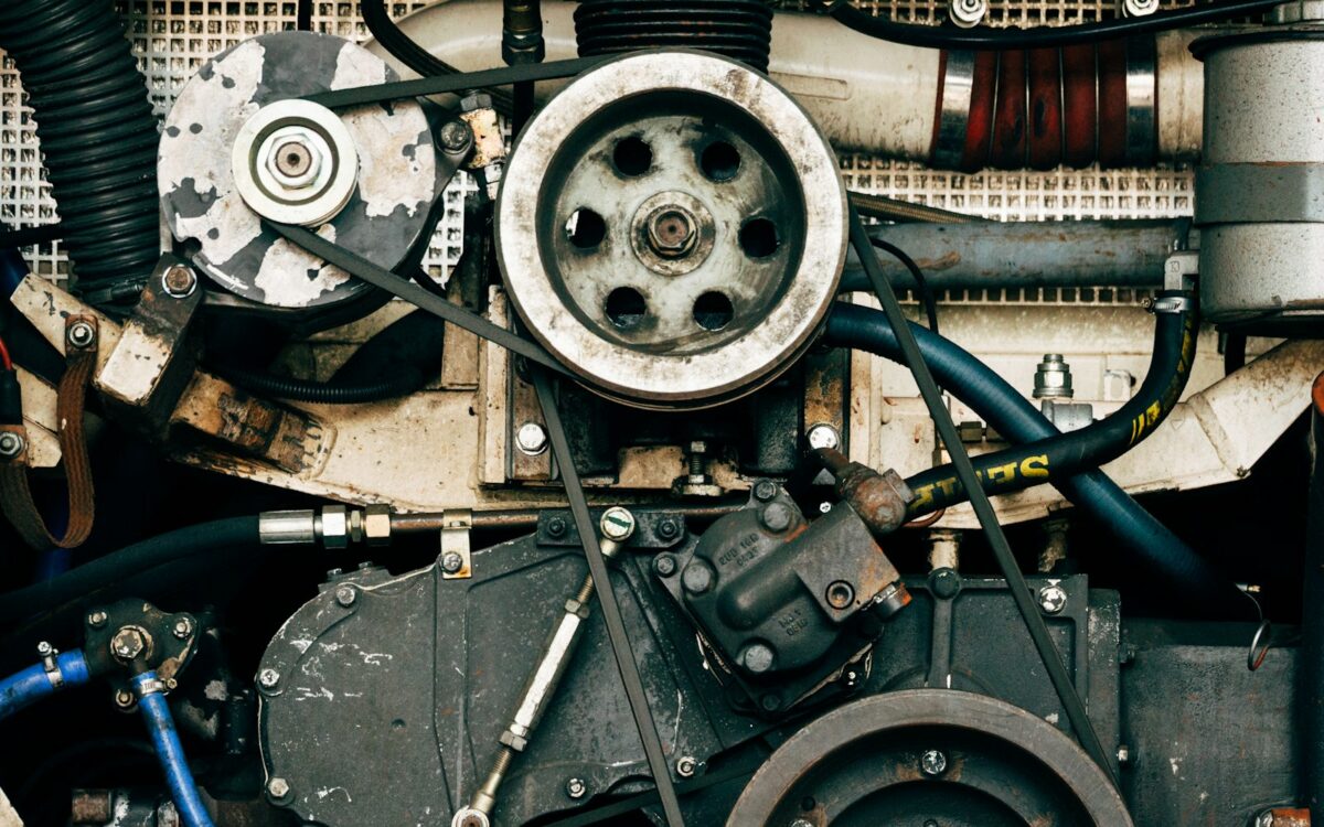 Engine drive belt running around several pulleys at the front of an engine