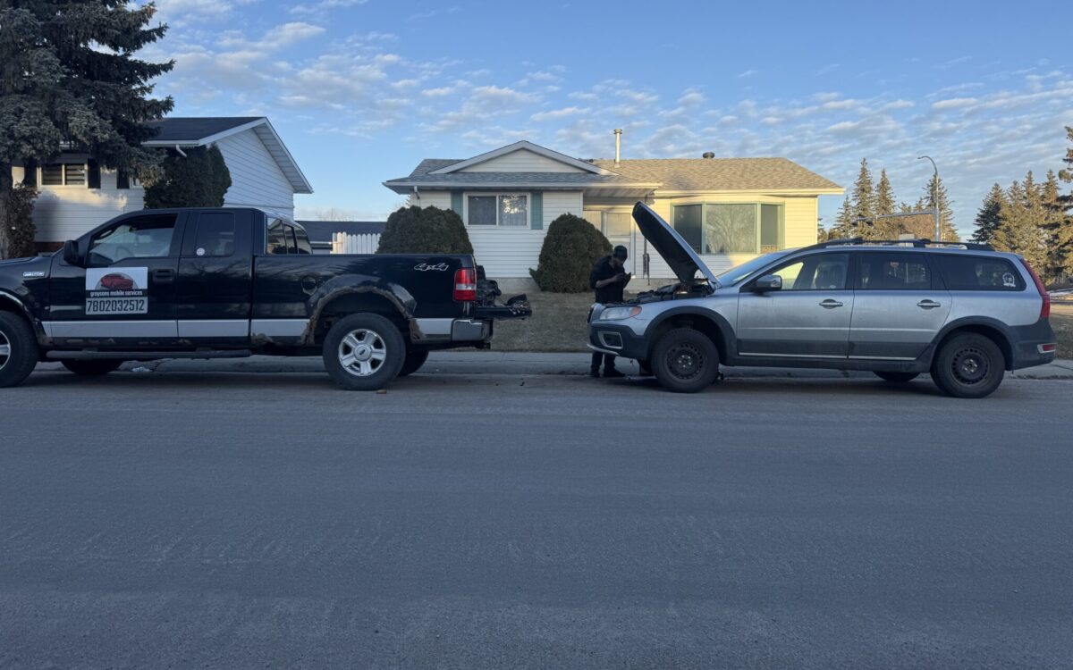 Grayson Mobile Mechanic truck parked beside a customer car with the hood open for on-site maintenance in Edmonton