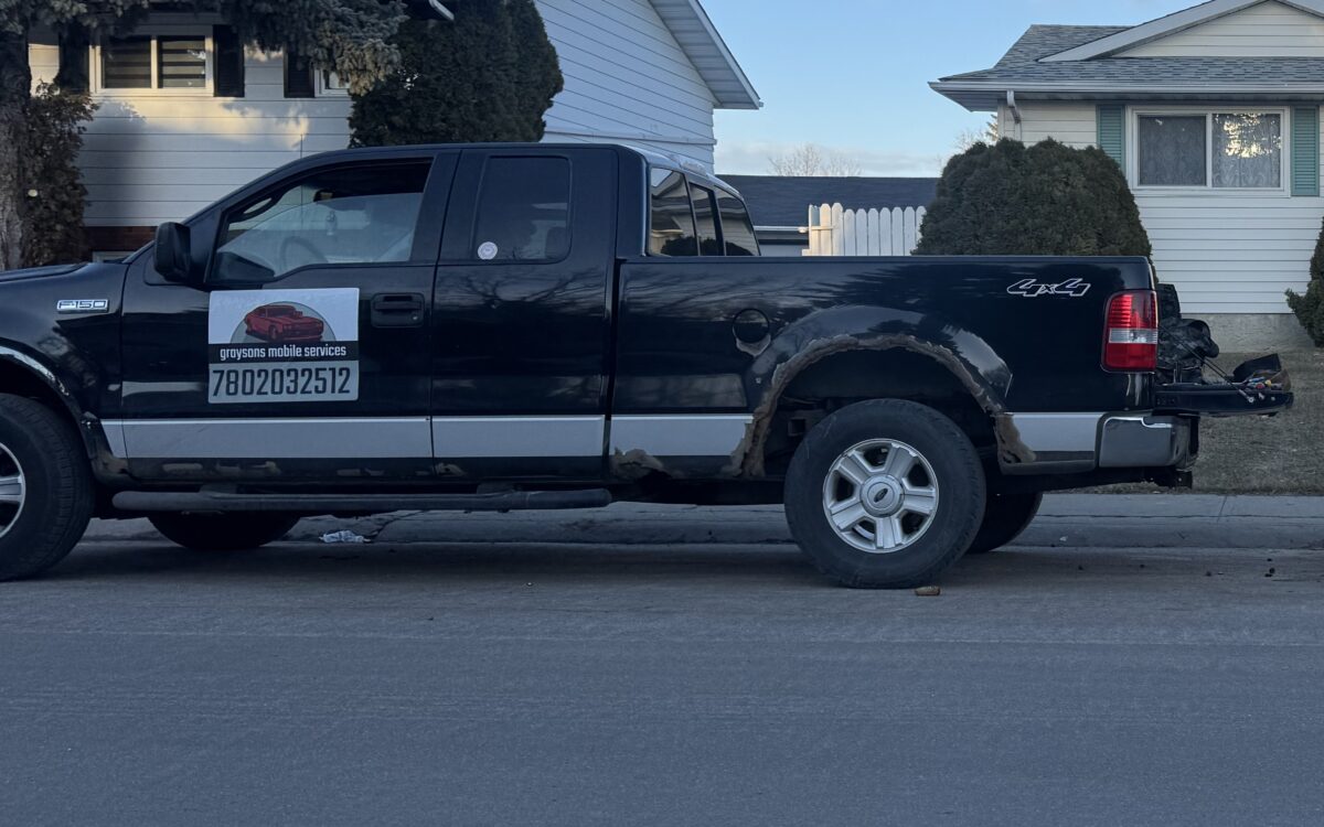 Grayson Mobile Mechanic service truck with company logo and phone number parked on an Edmonton street